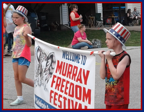 Kids carrying banner in parade